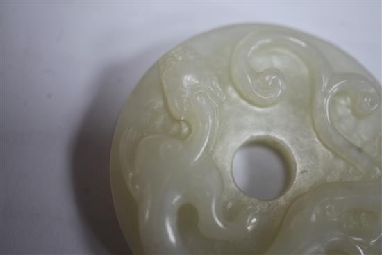 A Chinese white jade bi disc, diameter 4.6cm, wood stand